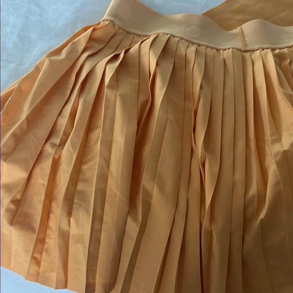 ALO Yoga Pleated Mini Skirt in Peach Orange